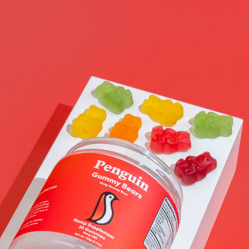 Penguin Gummy Bears packaging with gummy bears on a red background