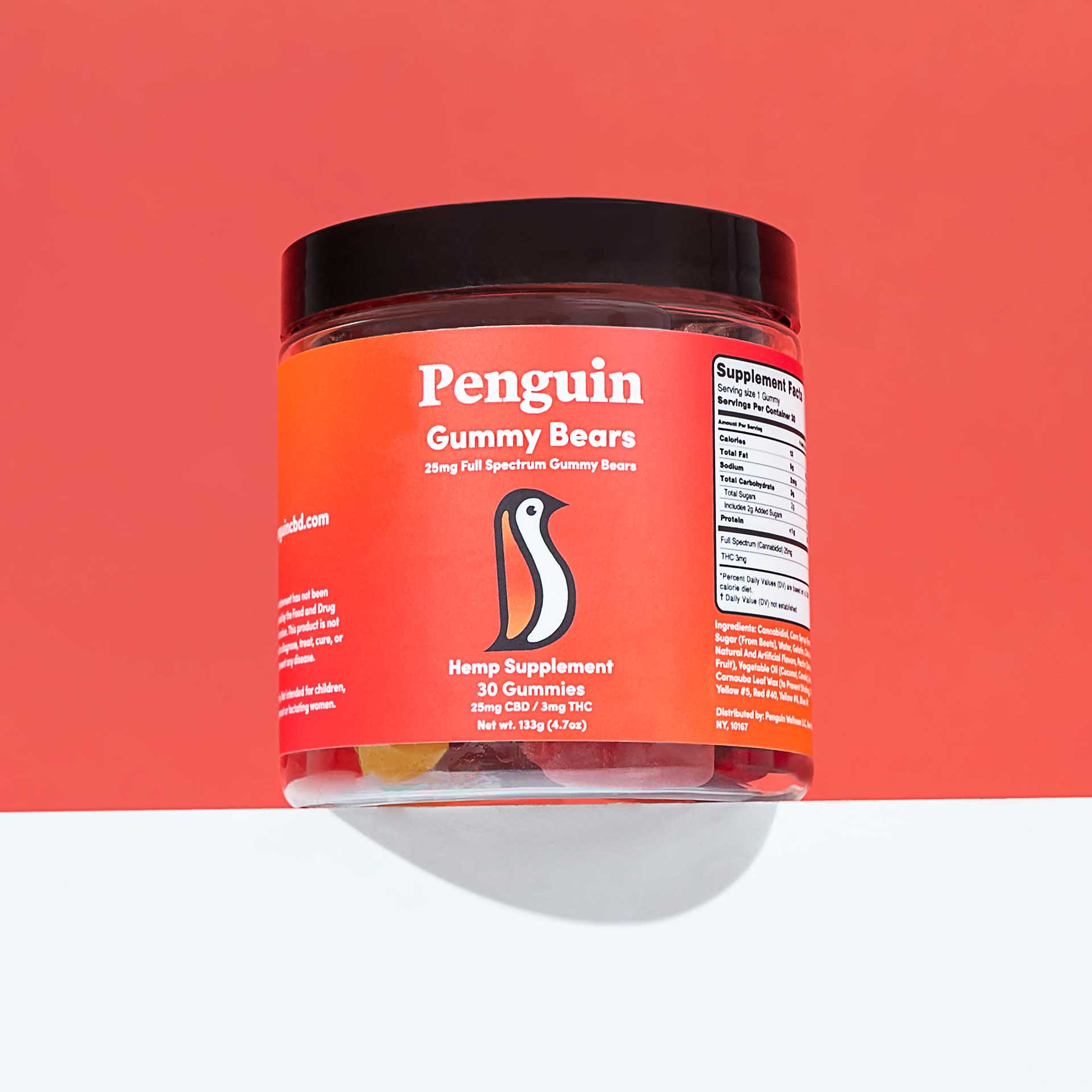 Jar of Penguin Gummy Bears hemp supplement on a red background